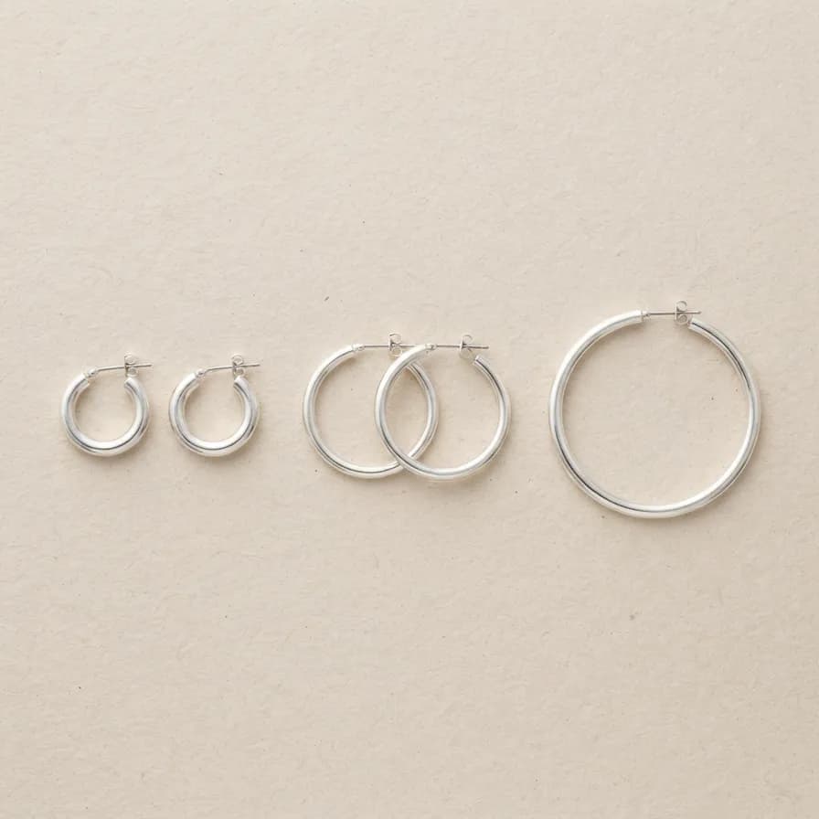 AI-generated jewelry photography example — Silver hoops flat lay, made with Nano Banana 2 Lite on BananaBanana